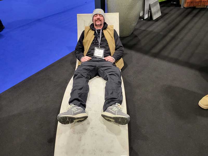 man with woolly hat relaxes on stylish lounger