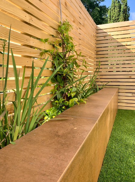 attractive garden wall decorated with corten steel coloured porcelain tiles