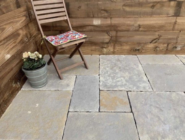 small seating area paved with antique yellow limestone paving