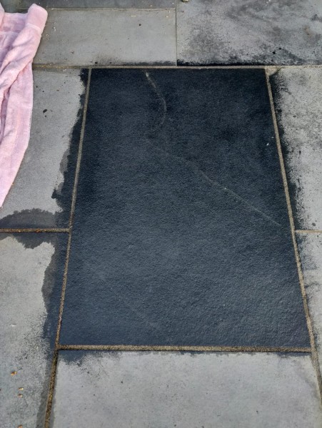 paving slab appearing darker than its neighbours after treatment with stone colour enhancer