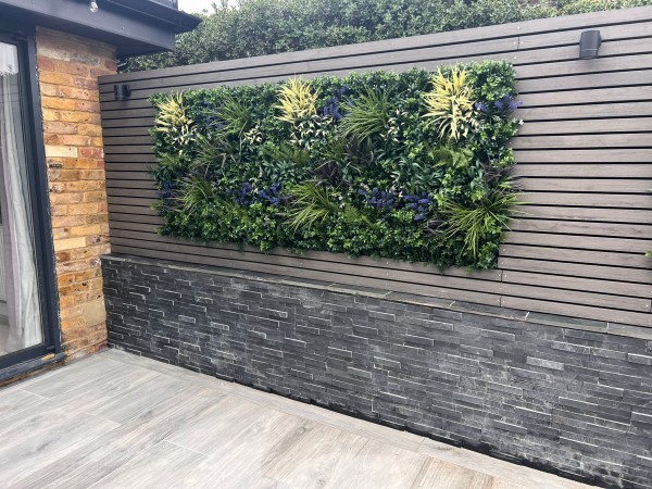 Attractive garden with raised bed, horizontal timber fencing and green wall panel