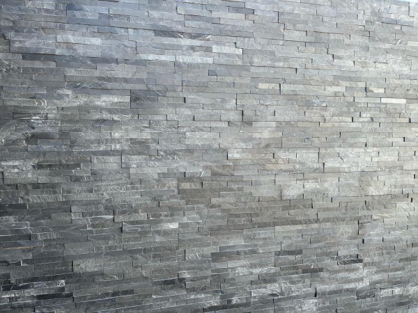 high garden wall with attractive stone tile cladding