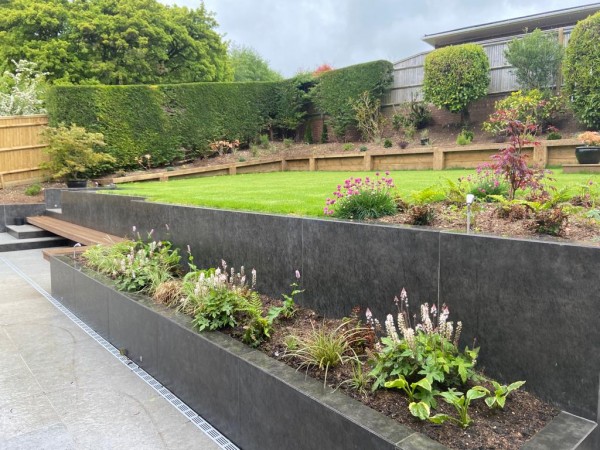 Xtech clad walls and beds used in landscaped garden 