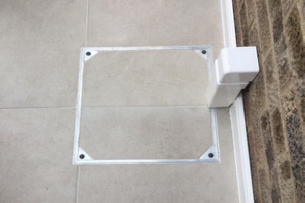stylish porcelain patio with recessed manhole cover