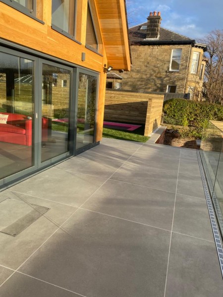 Patio with steel threshold drains 