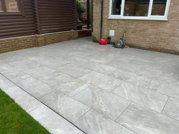 attractive small patio created using grey cardosa grigio porcelain paving