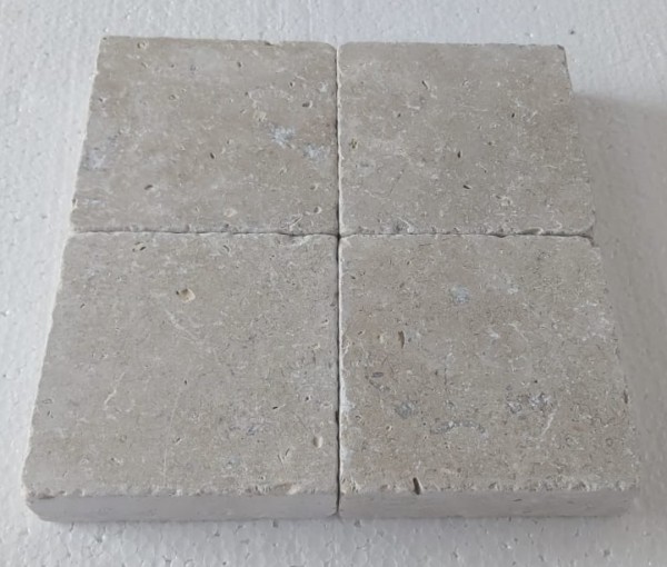 four limestone setts arranged in a square pattern