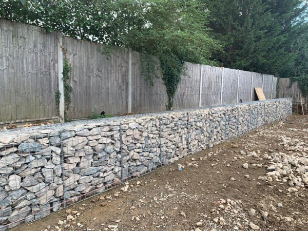 gabion basket retaining wall with timber fence on top
