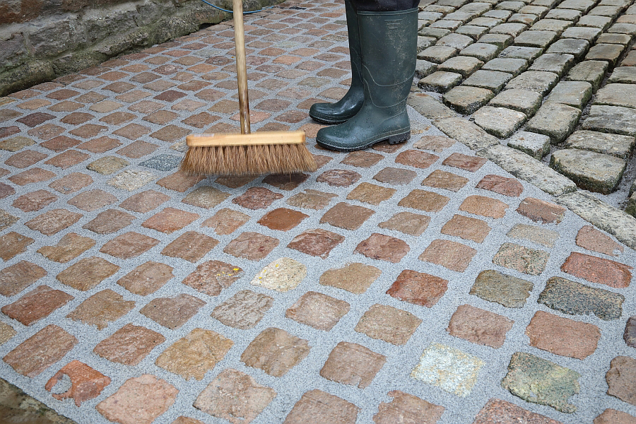 sweeping paved area which has been pointed using GFTK grout mix