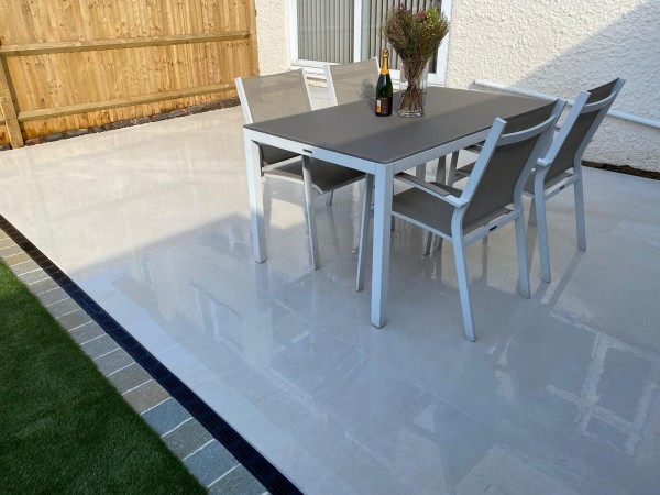 dining table and chairs set on pale beige coloured patio