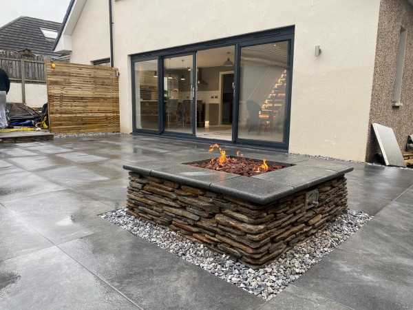 Fire pit located on garden patio topped with fusion graphite paving 