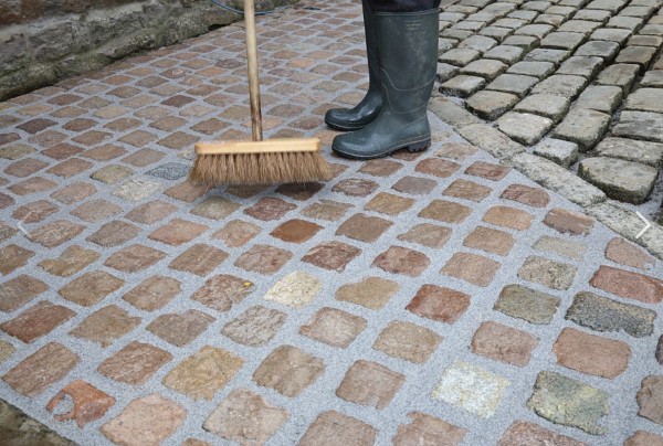 Sweeping newly grouted paved area