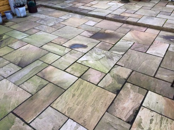 grimy patio with algae stains awaiting cleansing with S-Tech stone and masonry cleaner