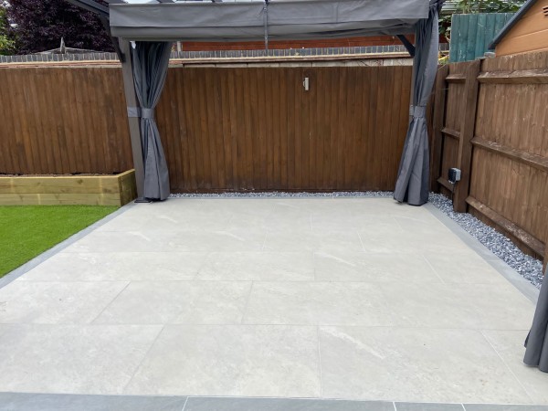 Patio of white porcelain paving in domestic garden