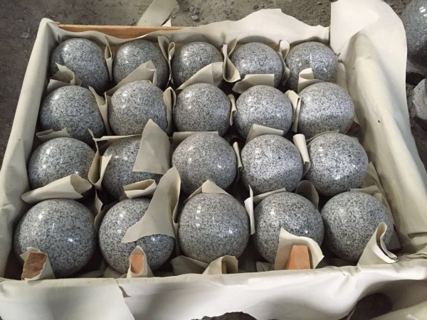 twenty small stone globes packaged for transportation