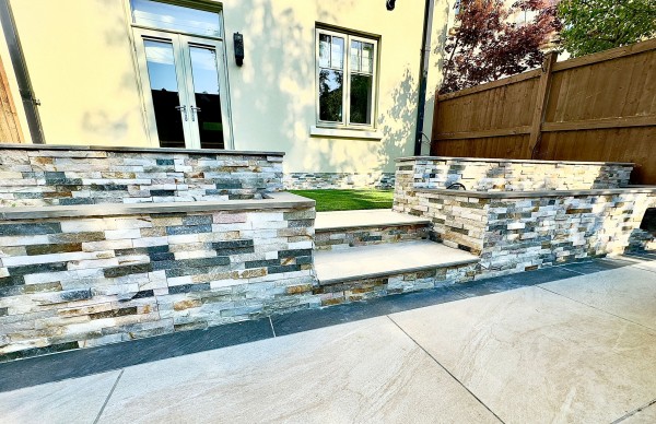 retaining wall clad with split face stone tile cladding