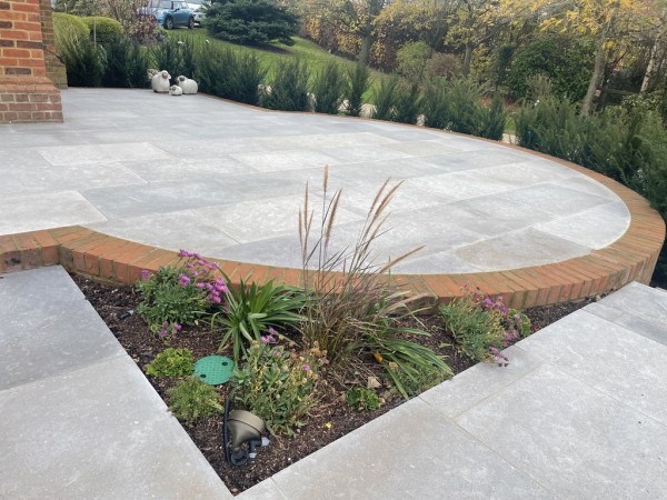 curvaceous patio built using Sinai Pearl Grey Limestone pavers from Arbour Landscape Solutions
