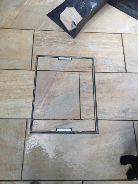 sandstone patio with recessed manhole cover and epoxy resin grout