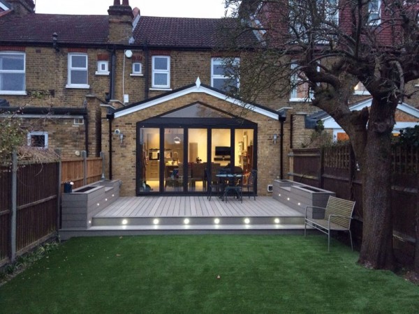 grey composite decking seating area with recessed lighting adjacent to patio doors