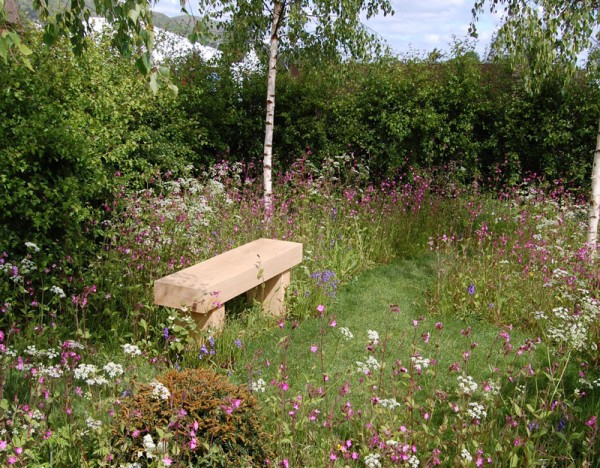Seating in a garden with wildflower borders 