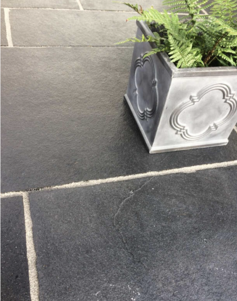 Dramatic black limestone paving with pale coloured grout
