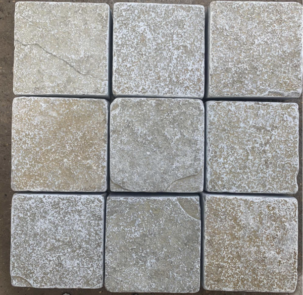 Nine tumbled yellow limestone setts arranged in a square