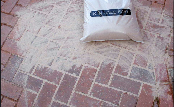 Kiln dried sand being used on paving