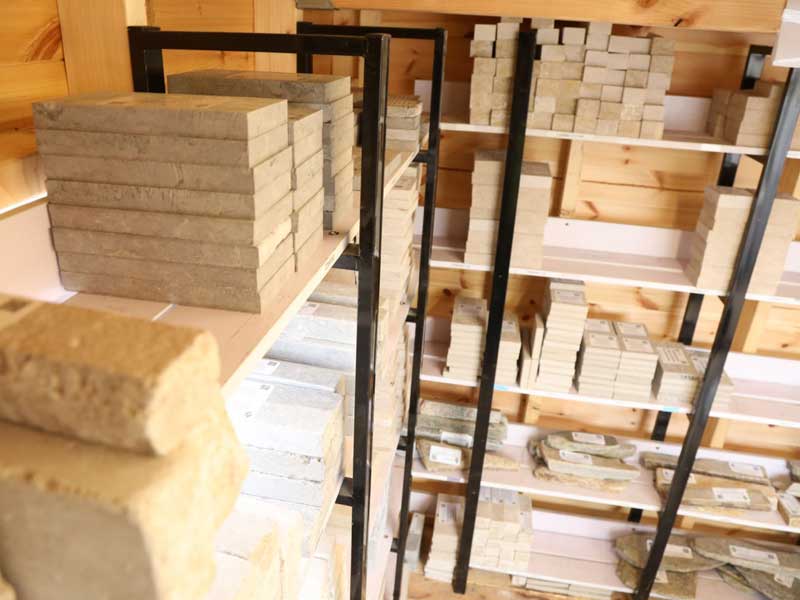inside the samples shed at Arbour Landscape Solutions. A selection of stone and paving samples neatly arranged on shelves