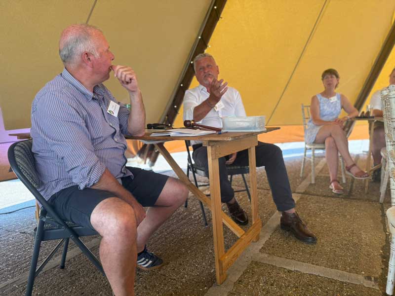 Phil Tremayne, and Mark Gregory sitting either side of a table in full discussion