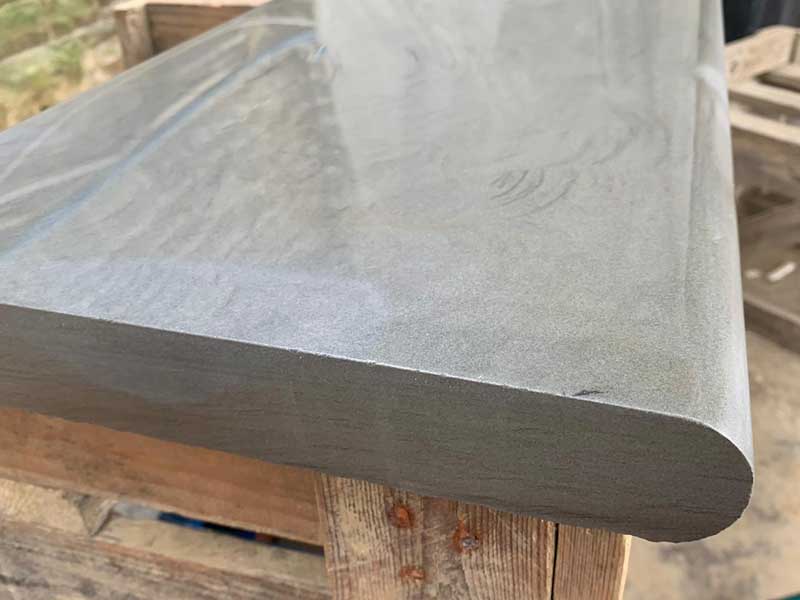 bespoke pool coping stone in grey coloured natural stone with beautifully curved edges