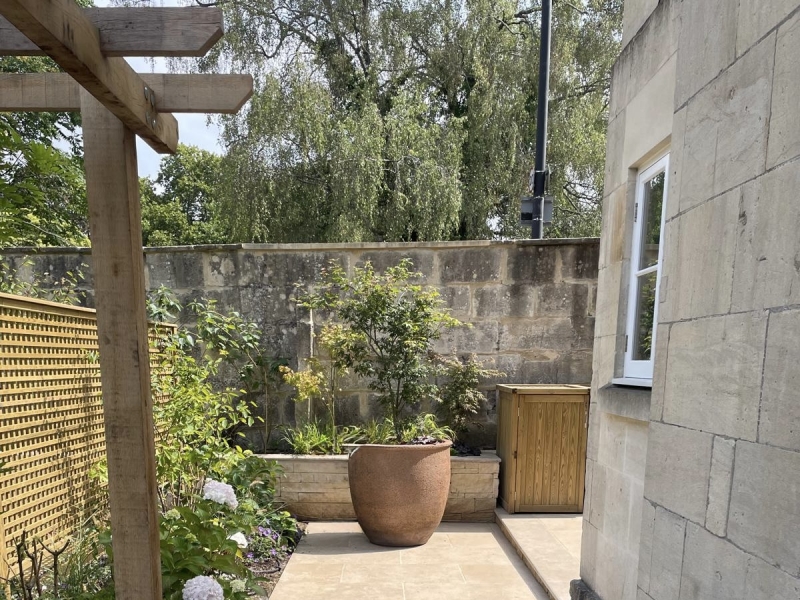 limestone setts laid in a herringbone pattern to contrast with surrounding paving slabs