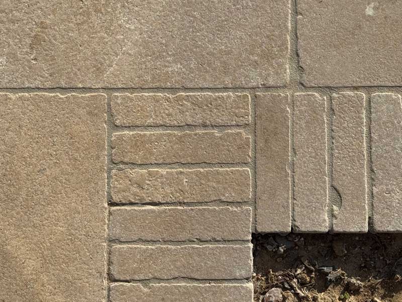 close up detail of limestone pavers and setts neatly installed and grouted