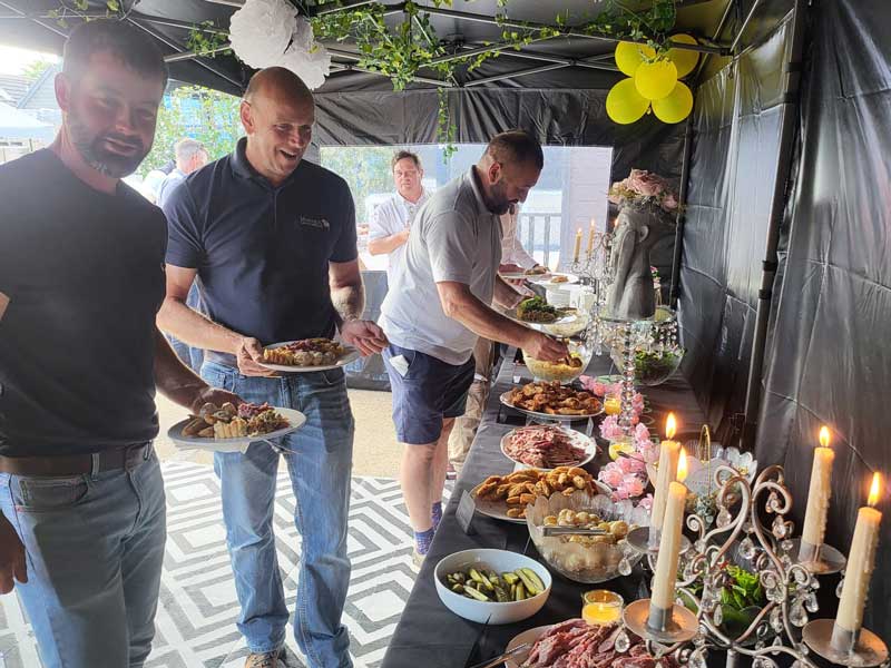 landscapers enjoying a buffet meal at arbour landscape solutions event