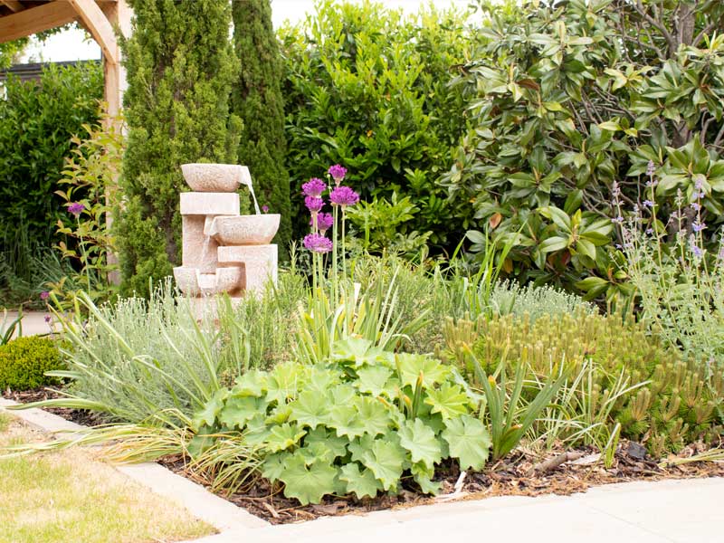 lovely planting scheme around a bespoke stone water feature