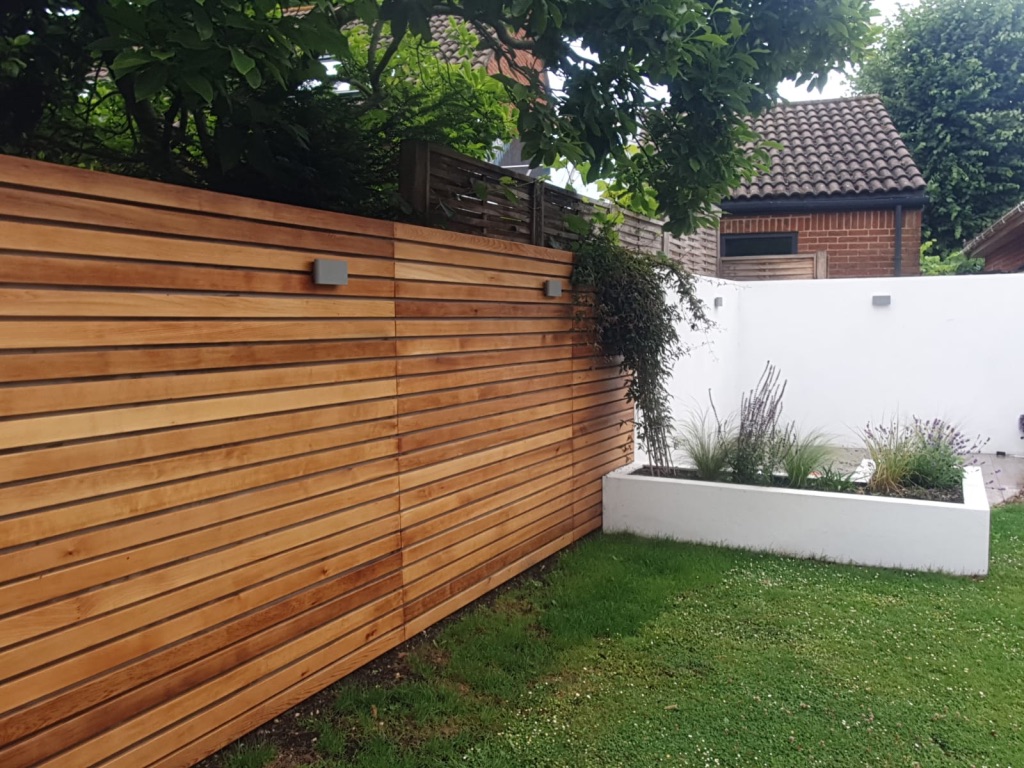 garden with lateral timber fence and white accented walls