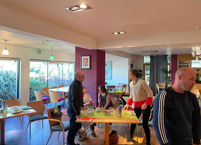 group of garden designers discussing landscaping materials over a cup of coffee