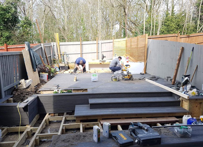 London Solid Composite Decking from Arbour Landscape Solutions being installed in a garden in Mill Hill
