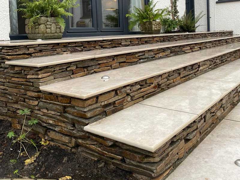 Paddlestones used as step risers to contrast with natural limestone treads. Great construction from Concept Landscapes