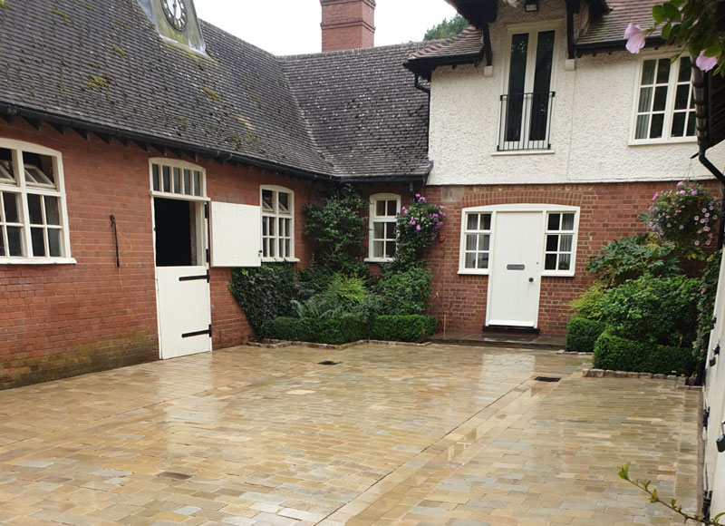 beautiful courtyard garden with stables, garages and house on three sides