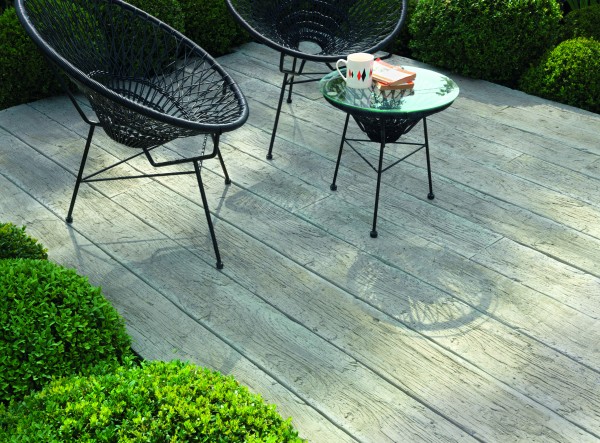 composite decking with natural driftwood appearance furnished with contemporary woven garden chairs