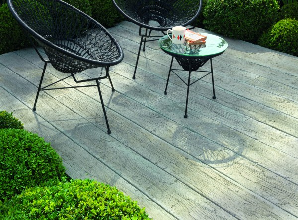 composite decking with natural driftwood appearance furnished with contemporary woven garden chairs