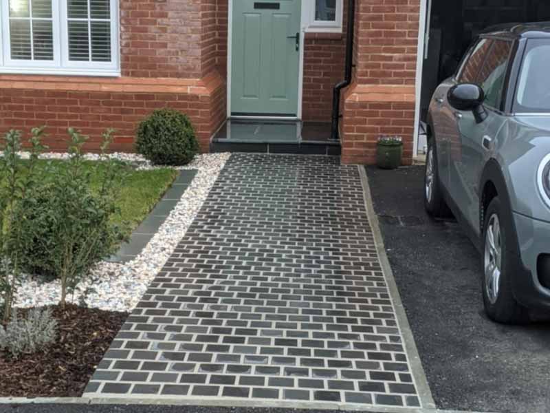 elegant small driveway design with striking pathway and areas of planting