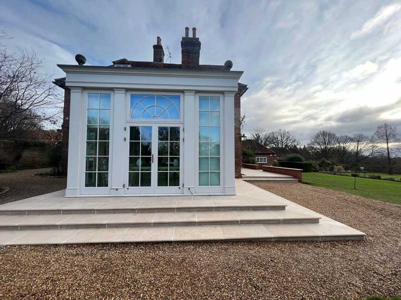 regency style garden room with landscaped steps leading to an elegant terrace