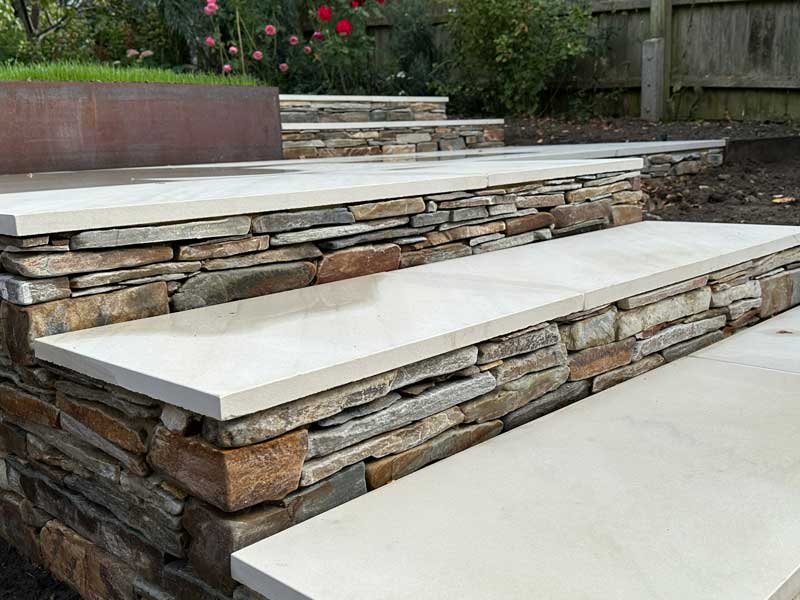 clever use of natural stone treads with paddlestone risers for garden steps