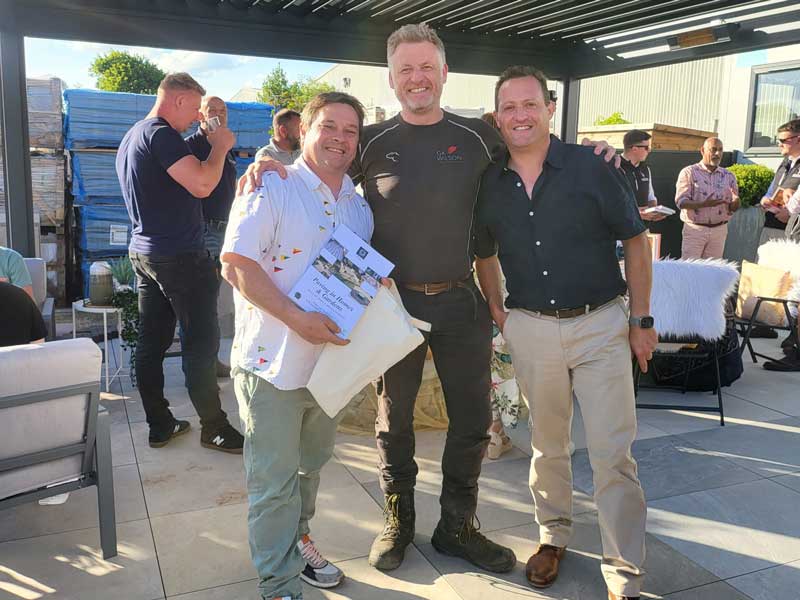 Gareth Wilson and Richard Bickler with guests at social event