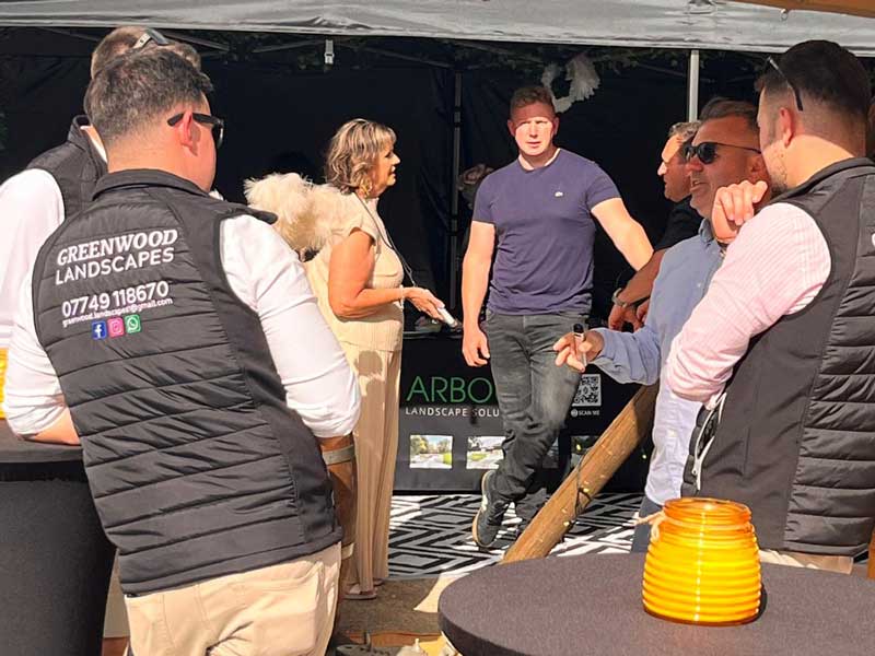 relaxed gathering with lively conversation at summer landscaping event