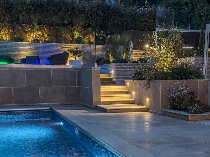 private swimming pool with surrounded by bespoke natural stone pavers