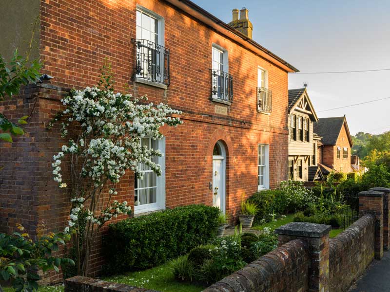 Red brick property in georgian style with elegant front garden designed by Julia Langsman