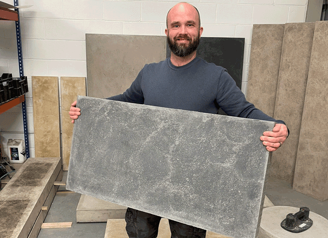 bearded gentleman lifts a 1200 x 600 concrete slab with ease