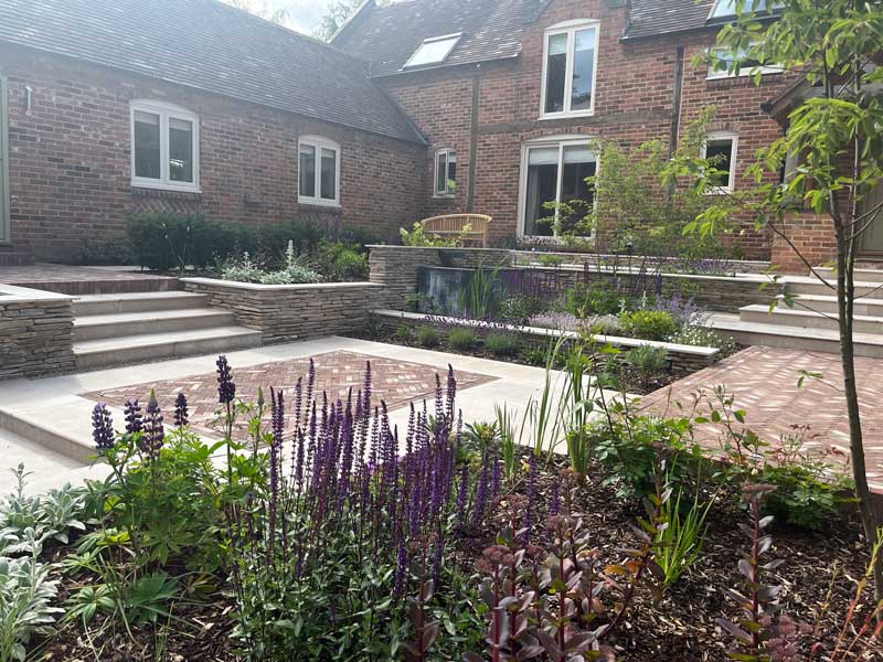 multi level farmhouse garden with paddlestone walling and attractive planting